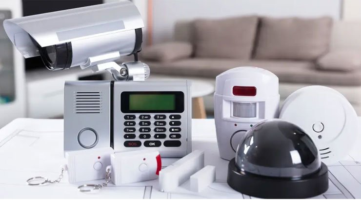 Alarm system installation in Uganda, Installer mounting a motion sensor alarm in a Ugandan home
