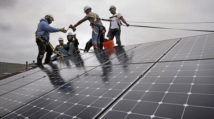 Technician installing solar wiring system on a rooftop in Uganda, Solar Wiring in Uganda